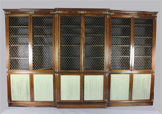 A suite of five Regency rosewood and brass mounted library bookcase cabinets, overall W.25ft 4in. approx.